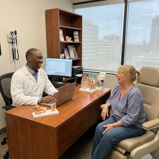 Robert Cousins meeting with a patient for a hearing aid consultation