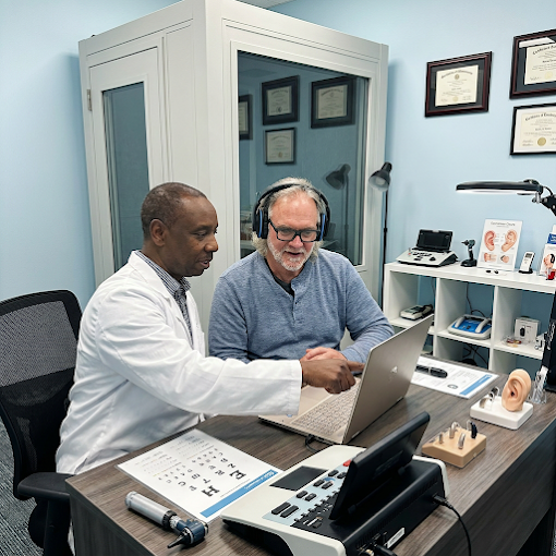 Robert Cousins conducting a hearing test with a patient